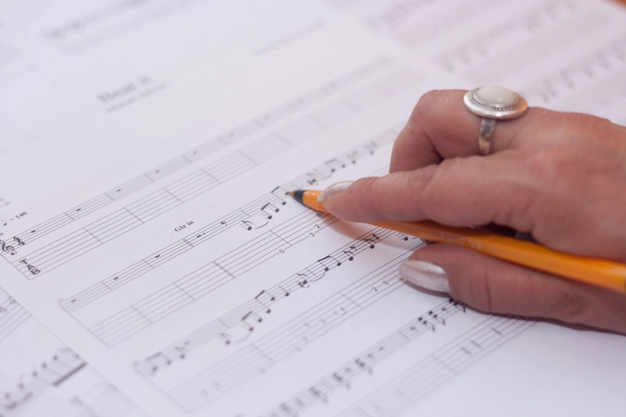 hand with pencil and music